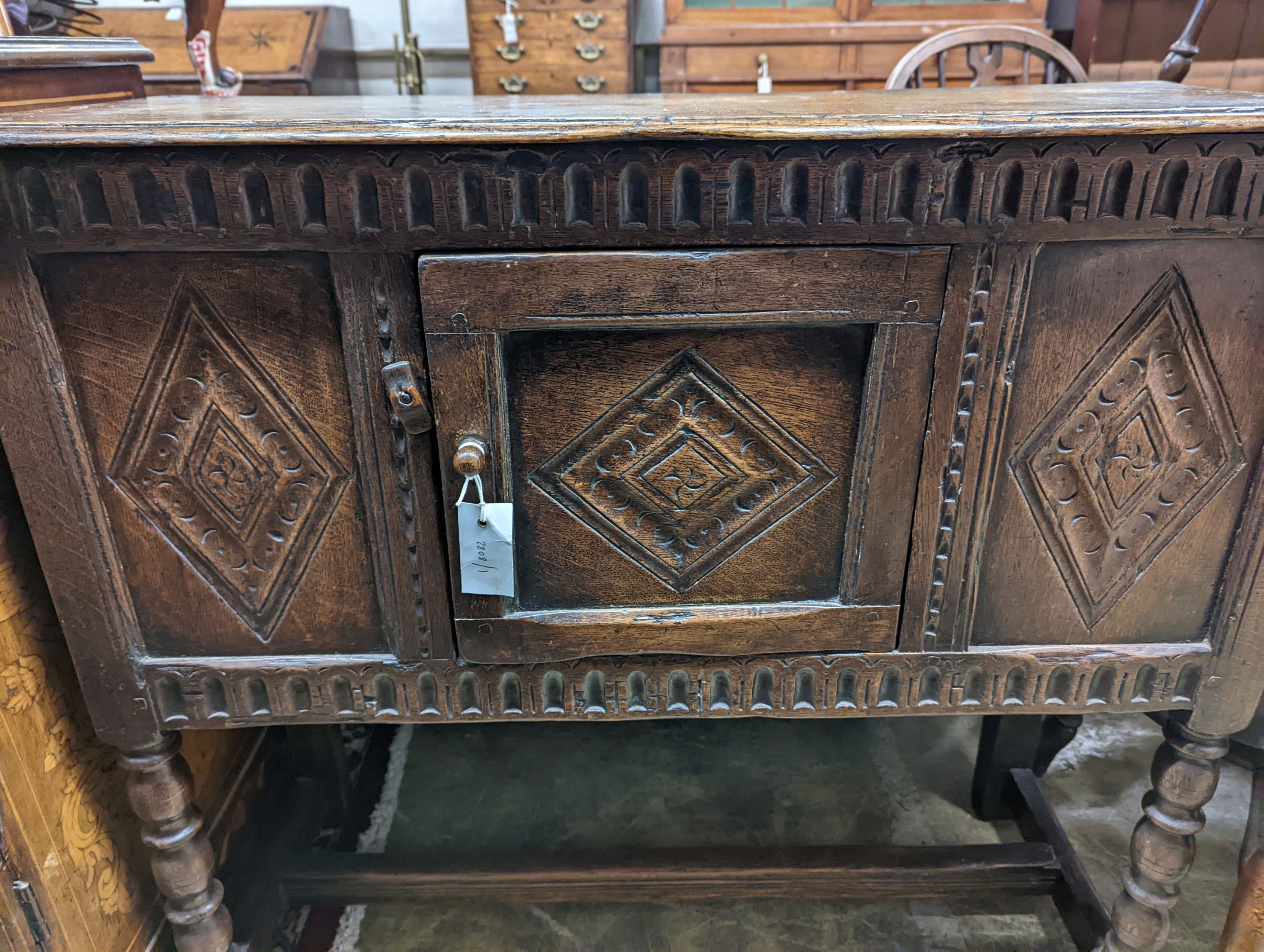 An 18th century style carved oak side cabinet, width 90cm, depth 35cm, height 83cm